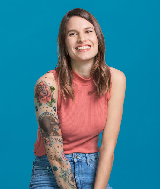 portrait of woman smiling in front of a blue background