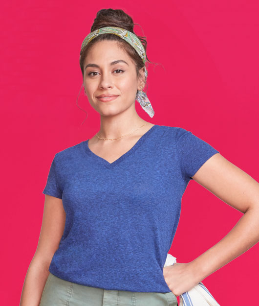 woman holding a towel posing in front of a pink background