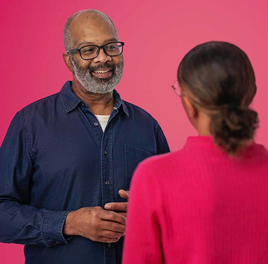 Man and woman talking on pink background